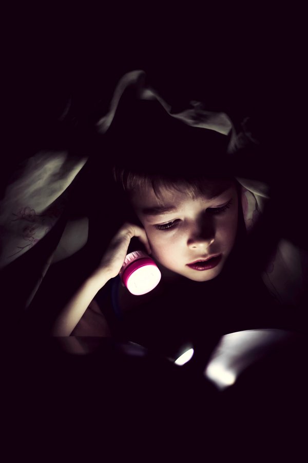 Staying up late, reading with a flashlight.